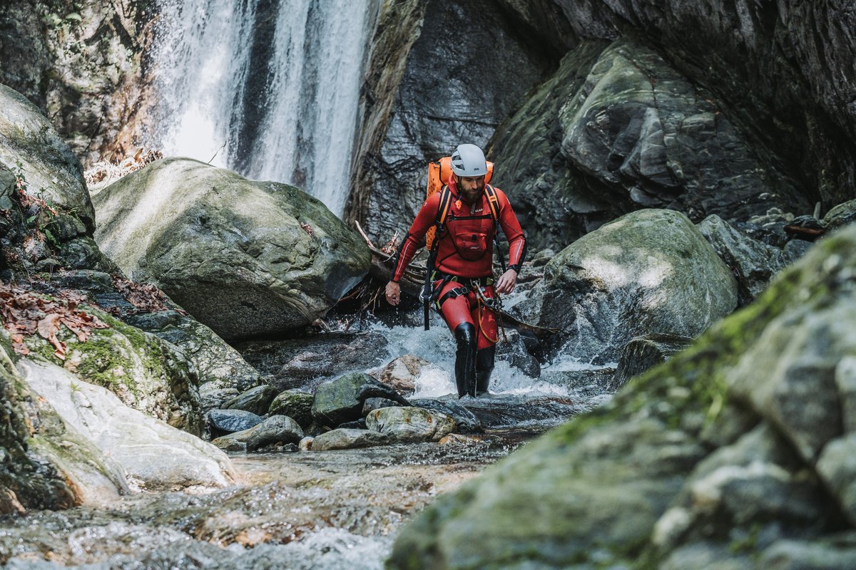 Guide steht vor Wasserfall in der Tessiner Schlucht